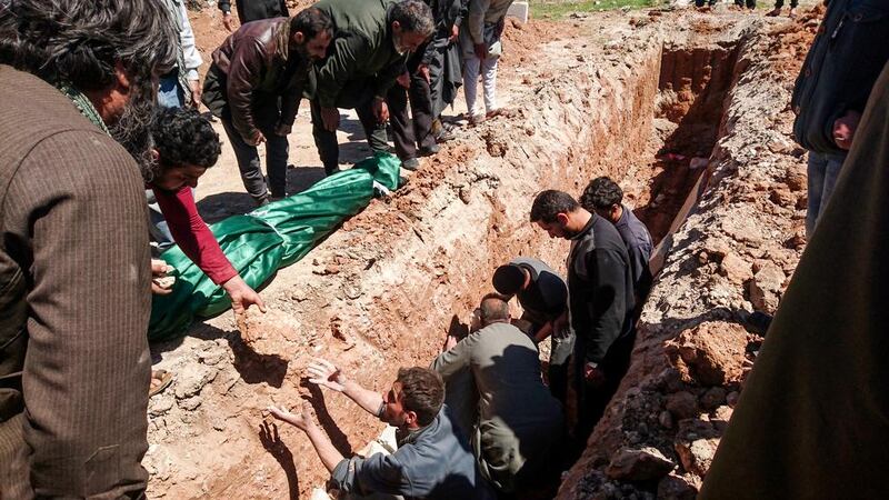 Syrians dig a grave on April 5, 2017 to bury the victims of the April 4 chemical attack in Khan Sheikhoun, a rebel-held town in Syria’s northwestern Idlib province. Fadi Al Halabi / AFP Photo