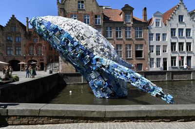 A 12-metre installation depicting a whale, made up of five tons of plastic waste pulled out of the Pacific Ocean, is displayed in Brugges, on July 14, 2018 for the 2018 Bruges Triennial.  / AFP / JOHN THYS
