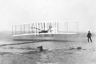Orville Wright is at the controls of the Wright Flyer as his brother Wilbur looks on during the world's first powered flight at Kitty Hawk, North Carolina, on December 17, 1903. AP