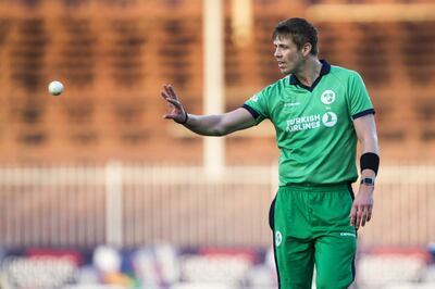 Ireland's Boyd Rankin pick up a ball during the third one day international (ODI) cricket match between Afghanistan and Ireland at Sharjah Cricket Association Stadium in Sharjah on December 10, 2017. / AFP PHOTO / NEZAR BALOUT