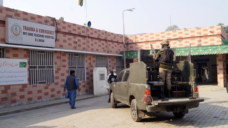 Pakistani Army soldiers stand guard outside the hospital after police officers were injured when militants stormed a police station in Chodwan. EPA