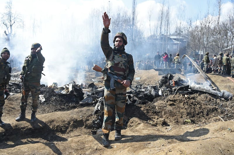 Indian soldiers gesture near the remains of an Indian Air Force aircraft after it crashed in Budgam district, 30km from Srinagar.  AFP