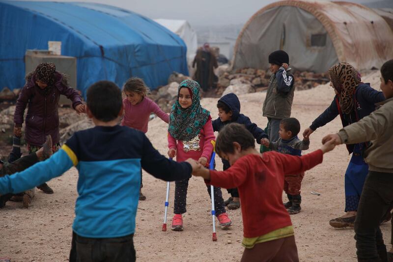 Maya Merhi plays with her friends at the camp of Serjilla in north-western Syria. AFP