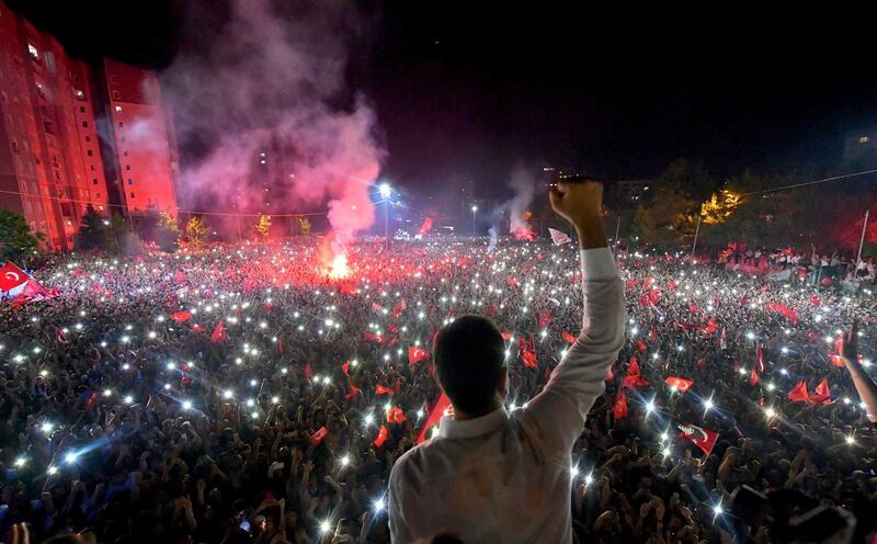 Ekrem Imamoglu, the candidate of the secular opposition Republican People's Party, CHP, waves to supporters at a rally in Istanbul, late Sunday, June 23, 2019. The opposition candidate for mayor of Istanbul celebrated a landmark win Sunday in a closely watched repeat election that ended weeks of political tension and broke the long hold President Recep Tayyip Erdogan's party had leading Turkey's largest city. (Onur Gunay/Imamoglu Media team via AP)