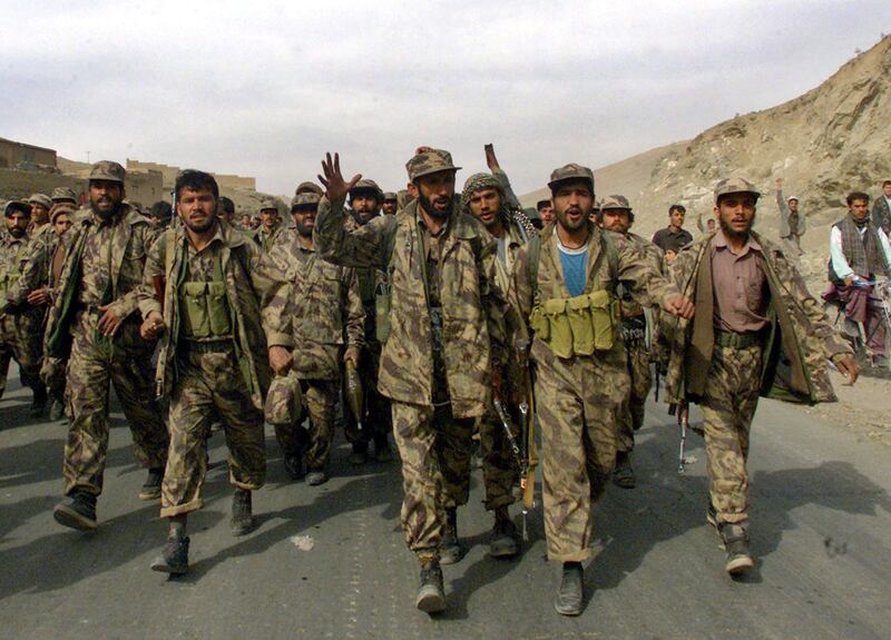 Northern Alliance fighters sing patriotic songs as they enter the capital Kabul in November 2001.