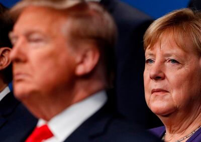 (FILES) In this file photo taken on December 04, 2019 German Chancellor Angela Merkel (R) poses with NATO leaders including US President Donald Trump (L) for the family photo at the NATO summit at the Grove hotel in Watford, northeast of London. President Donald Trump has clashed with plenty of US allies. But toward German Chancellor Angela Merkel, he appears to hold special enmity. / AFP / POOL / PETER NICHOLLS
