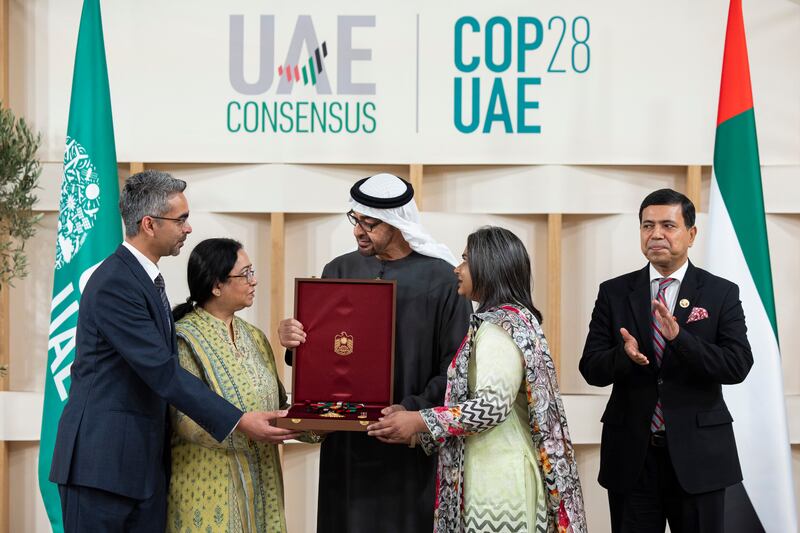 Sheikh Mohamed presents the First Class Order of Zayed II medal to the late Prof Saleemul Huq, founding director of the International Centre for Climate Change and Development in Bangladesh. The award was received by members of his family. Ryan Carter / Presidential Court