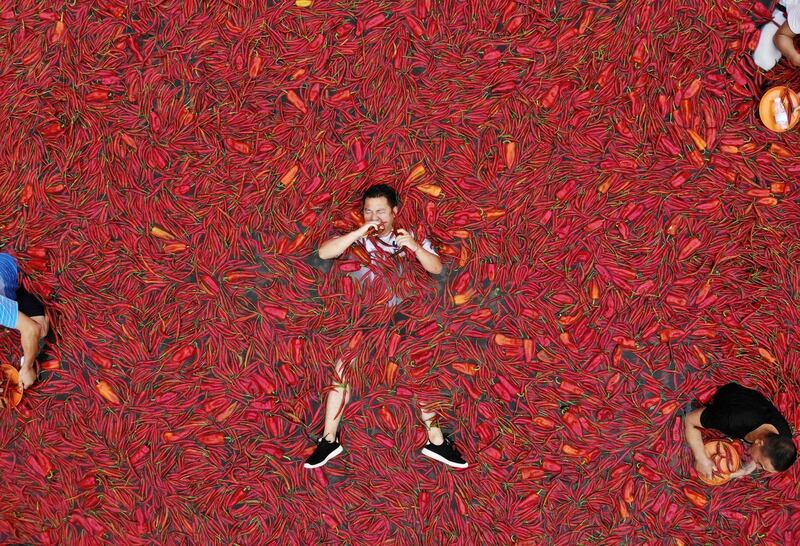 A contestant takes part in a chilli pepper eating competition in Ningxiang in China's central Hunan province. The winner of the contest ate 50 chilli peppers in one minute. AFP Photo