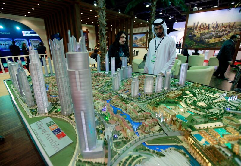 Dubai , United Arab Emirates- September 27,  2011:    Visitors browse the  Dubai Land's City of Arabia projects  at Cityscape Global in Dubai.  ( Satish Kumar / The National ) For Business