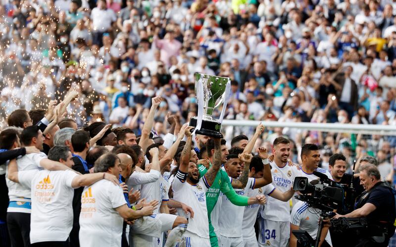 Real Madrid's Marcelo holds the trophy. Reuters