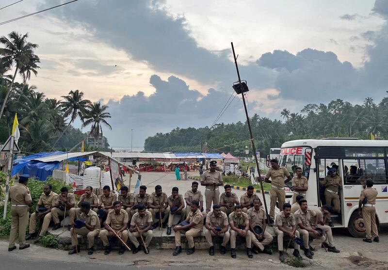 Policemen at the entrance of the proposed Vizhinjam Port in India's Kerala state, which, residents say, is destroying the local ecosystem. Reuters