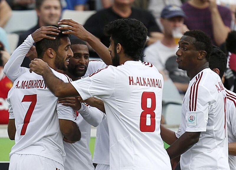 UAE national football team players celebrate with Ali Mabkhout, left No 7, after one of his two goals against Qatar in a 4-1 Asian Cup Group C victory on Sunday in Canberra, Australia. Tim Wimborne / Reuters