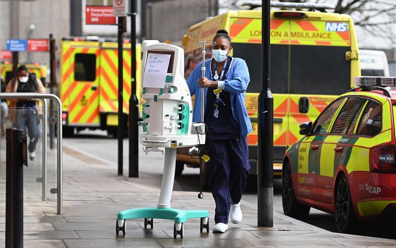 NHS staff with a dialysis filter machine outside the Royal London hospital. AFP