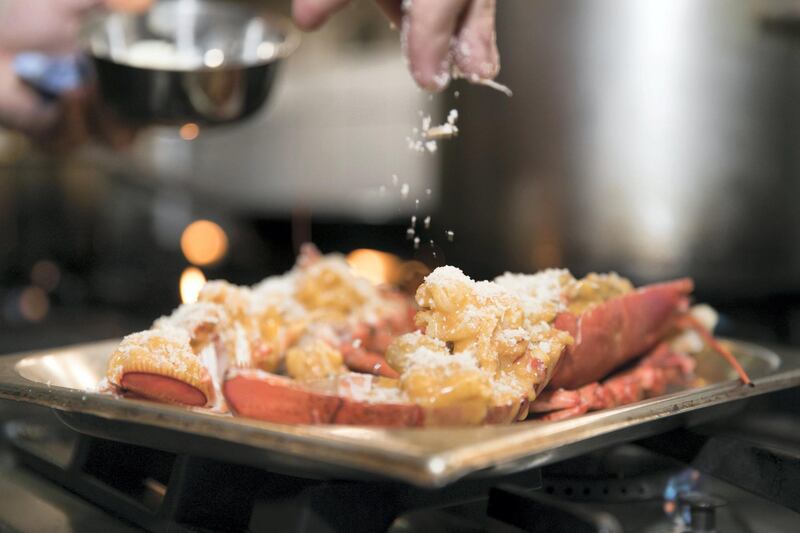 ABU DHABI, UNITED ARAB EMIRATES - MARCH 27, 2018. 

Chef Theodoris Rouvas, from Bentley Kitchen, prepares a Lobster Thermidor.

Chef Theo stuffs the emptied lobster tail with the filling and tops it with the grated cheese.

(Photo by Reem Mohammed/The National)

Reporter: 
Section: AC