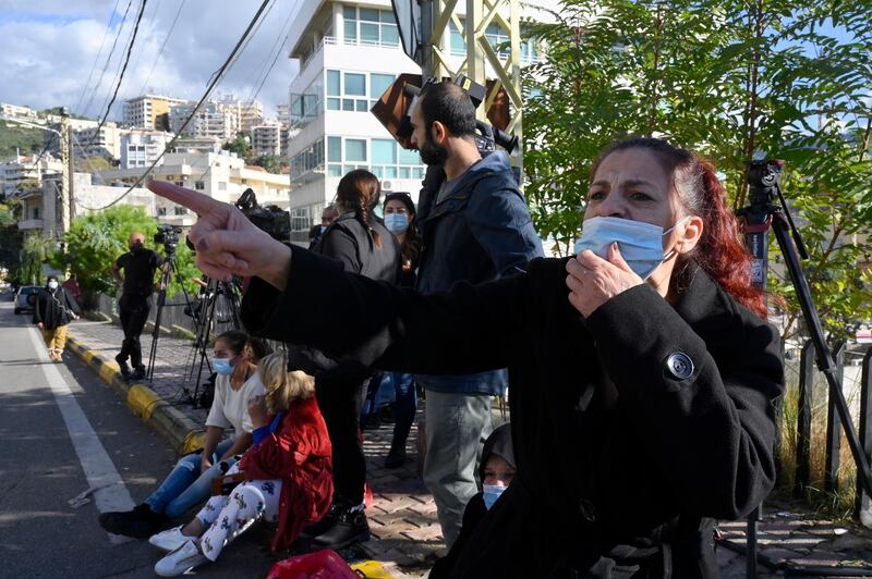 Families and relatives of fugitive prisoners who had fled a detention center shout slogans as they gather in Baabda.  EPA