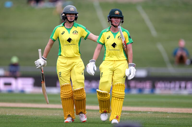 Australia's Beth Mooney walks from the field with teammate Ellyse Perry at the end of a cricket match against rivals New Zealand.  AFP