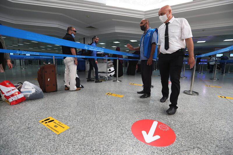 Passengers wait in line for check-in for their repatriation flight for Libya, at the Tunis Carthage International Airport in Tunis, Tunisia. EPA