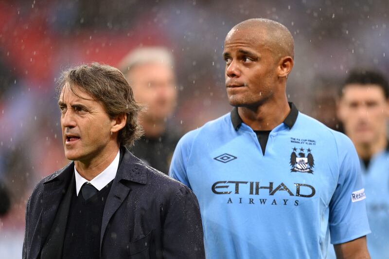 LONDON, ENGLAND - MAY 11:  Manager Roberto Mancini of Manchester City and Vincent Kompany look dejected in defeat after the FA Cup with Budweiser Final between Manchester City and Wigan Athletic at Wembley Stadium on May 11, 2013 in London, England.  (Photo by Mike Hewitt/Getty Images) *** Local Caption ***  168559198.jpg