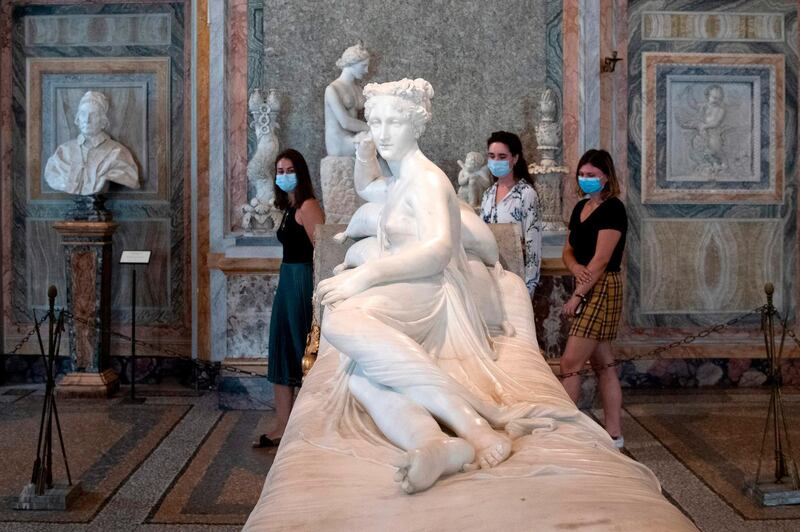 Visitors wearing a face mask view "Paolina Borghese Bonaparte as Venus Victrix", a 1805-1808 marble sculpture by Antonio Canova at the Galleria Borghese museum in Rome.  AFP