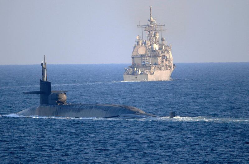 In this photo made available by the U.S. Navy, the guided-missile submarine USS Georgia, front, with the guided-missile cruiser USS Port Royal, transit the Strait of Hormuz in Persian Gulf, Monday, Dec. 21, 2020. The vessels traversed the strategically vital waterway between Iran and the Arabian Peninsula on Monday, the U.S. Navy said, a rare announcement that comes amid rising tensions with Iran. (Mass Communication Specialist 2nd Class Indra Beaufort/U.S. Navy via AP)