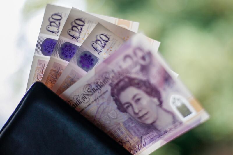 British twenty pound banknotes sit in a wallet in this arranged photograph in London, U.K., on Wednesday, Oct. 14, 2020. Pound traders are remarkably nonchalant even as U.K. Prime Minister Boris Johnson's self-imposed deadline of Oct. 15 to get a trade deal with the European Union looms large. Photographer: Hollie Adams/Bloomberg