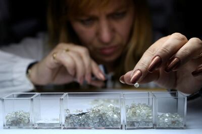 An employee sorts rough diamonds at a sorting centre owned by Russian mining major Alrosa in Moscow. Alrosa supplies about a third of the world’s raw gems and US sanctions against the company are causing panic in the industry. Reuters