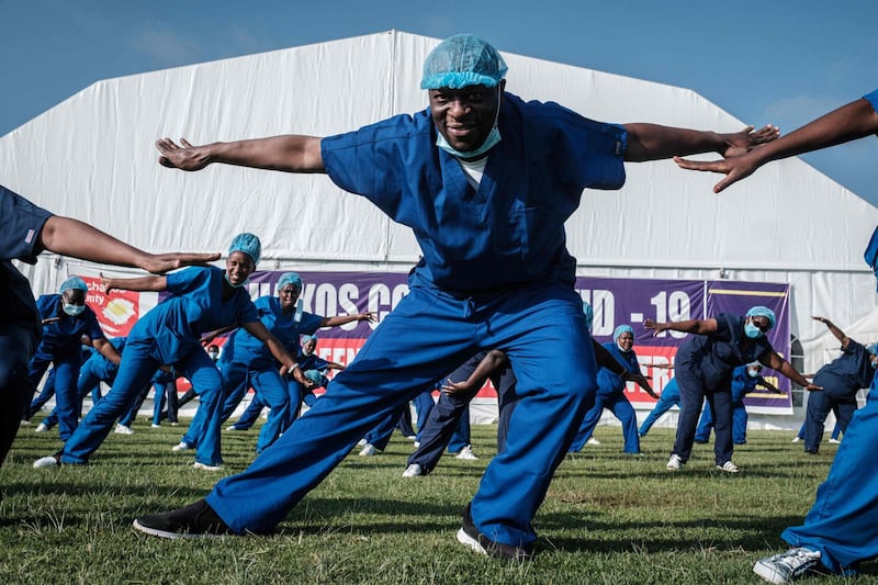Health care providers - nurses, doctors, midwives and health care workers- attend the 4th Zumba dance session organised by the Nursing Council of Kenya at Kenyatta stadium where screening booths and an isolation field hospital are installed, in Machakos, Kenya, on June 19. Yasuyoshi Chiba / AFP