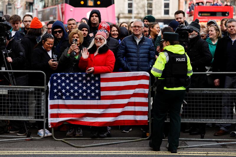 Well-wishers stand by a US flag in Belfast. Reuters
