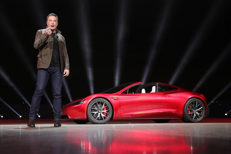 epa06335606 A handout photo made available by Tesla 16 November 2017, showing Tesla founder Elon Musk presenting the new Roadster electric sports vehicle (on background), presented to media 16 November 2017 at Tesla's Los Angeles design centre, Los Angeles, USA. Tesla says the Roadster will accelerate from 0-60 mph (or 0-96 km/h) in less than two seconds. Tesla says the new Roadster will cost 200,000 USD and will be released in some three years time. Tesla has began to take in orders for the new Roadster, and says new buyers will have to pay a 45,000 USD deposit. However, clients interested in buying one of the first 1,000 vehicles of the limited edition 'Founders Series' will have to pay 250,000 USD for the car.  EPA/TESLA HANDOUT  HANDOUT EDITORIAL USE ONLY/NO SALES