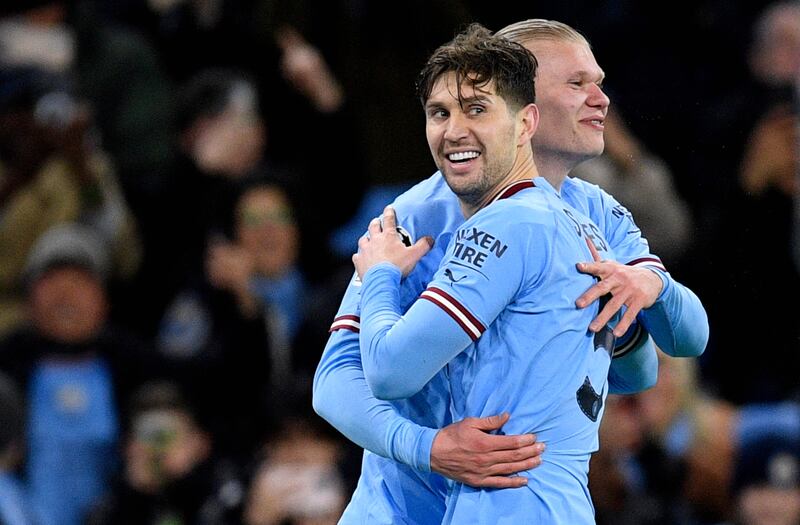 Haaland celebrates scoring the fifth goal with John Stones. AFP