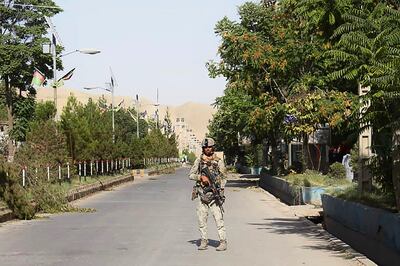 An Afghan security forces personnel stands guard along a road amid ongoing fighting with Taliban fighters in the western city of Qala -i Naw, the capital of Badghis province, on July 8. AP