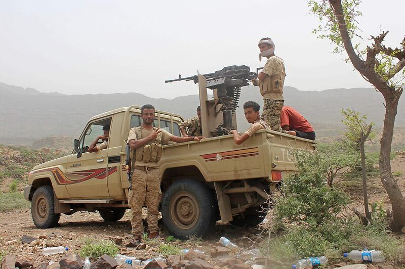 Yemeni pro-government fighters sit at the back of an armed pick-up as Emirati supported forces take over Huthi bases on the frontline of Kirsh between the province of Taez and Lahj, southwestern Yemen, on July 1, 2018. The United Arab Emirates on Sunday announced it had halted the offensive it is backing against Huthi rebels in Yemen's port city of Hodeida to give a chance to UN diplomatic efforts.
 / AFP / Saleh Al-OBEIDI
