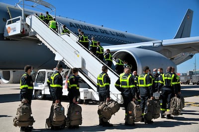 French Securite Civile rescue workers board a military plane at Roissy airport, north of Paris, Wednesday, Aug. 5, 2020. The French emergency workers traveling to Lebanon include members of a special unit with chemical and other technological expertise trained to intervene in damaged industrial sites. French President Emmanuel Macron announced he would fly to the shattered Lebanese capital, and two planeloads of French rescue workers and aid were expected to touch down on Wednesday afternoon. (Bertrand Guay, Pool via AP)