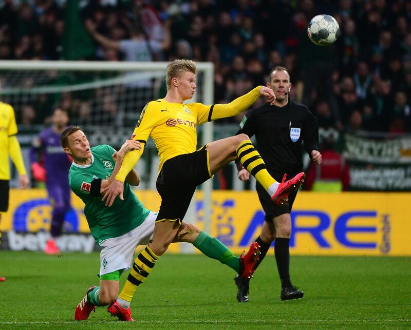 Bremen's Ludwig Augustinsson and Dortmund's Norwegian forward Erling Braut Haaland vie for the ball. AFP