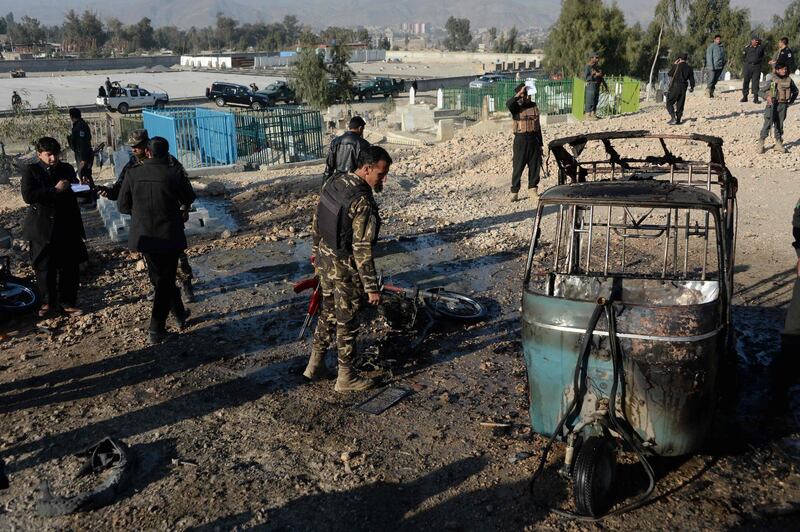 Afghan security personnel inspect the scene of a suicide attack that targeted a funeral ceremony in Jalalabad on December 31, 2017.
A suicide attacker blew himself up at a funeral in eastern Afghanistan on Sunday, killing at least 15 people and wounding another 14, officials said, capping a deadly year for civilians. While there was no immediate claim of responsiblity for the assault, Taliban and Islamic State militants have stepped up attacks in recent months, with ordinary Afghans bearing the brunt of the violence. 
 / AFP PHOTO / NOORULLAH SHIRZADA