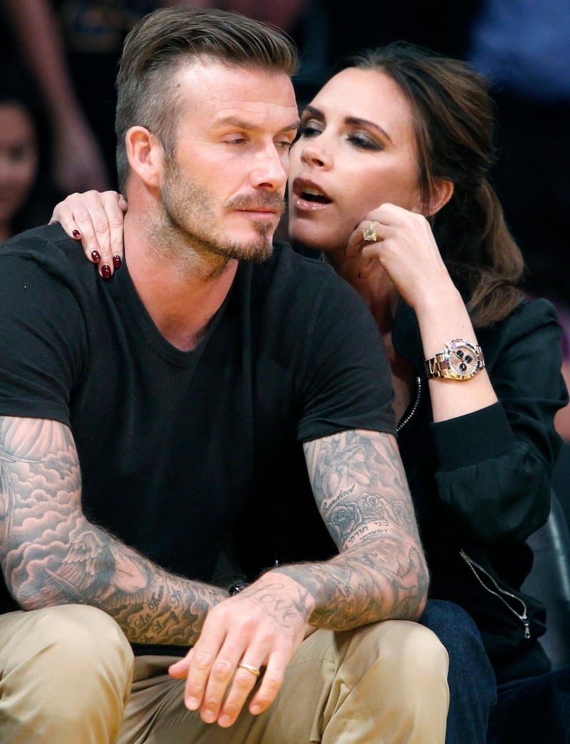 Soccer star David Beckham sits courtside with his wife Victoria during Game 2 of the Los Angeles Lakers against Denver Nuggets NBA Western Conference quarter-final basketball playoff game in Los Angeles, California in this May 1, 2012 file photo.  Former England captain David Beckham announced on May 16, 2013 that he will retire from professional soccer at the end of the season. REUTERS/Alex Gallardo/Files (UNITED STATES - Tags: SPORT BASKETBALL ENTERTAINMENT SOCCER TPX IMAGES OF THE DAY) *** Local Caption ***  SIN3_SOCCER-ENGLAND_0516_11.JPG