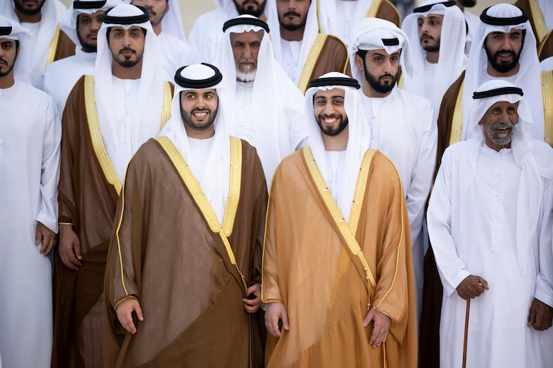 Sheikh Zayed bin Mansour bin Zayed (2nd R) and Sheikh Hazza bin Hamdan bin Zayed (3rd R) pose for a photograph during their group wedding at Qasr Al Hosn.