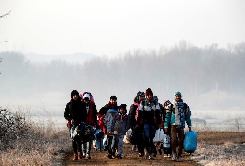 Migrants walk along the Evros river to reach Greece, near the Turkish border city of Edirne, Turkey, March 1, 2020. REUTERS/Umit Bektas
