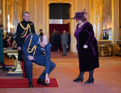 Prince William accidentally dropped the MBE he was presenting to charity worker Suzanne Hutchinson at Windsor Castle. PA