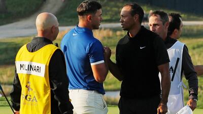 Brooks Koepka, left, and Tiger Woods shake hands after finishing the second round of the PGA Championship on Friday. AP Photo