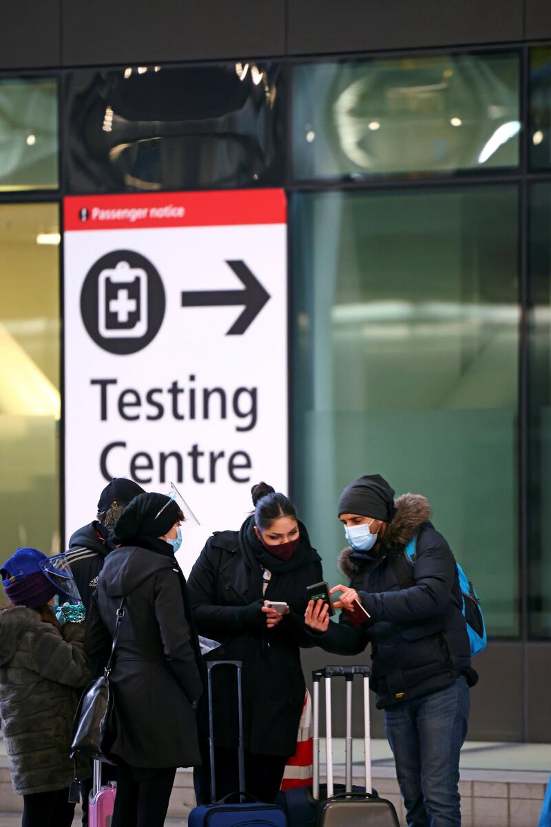 People stand near a testing centre, as tighter rules for international travellers start, at terminal 2 of the Heathrow Airport, amid the spread of the coronavirus disease (COVID-19) pandemic, London, Britain, January 18, 2021. REUTERS/Henry Nicholls