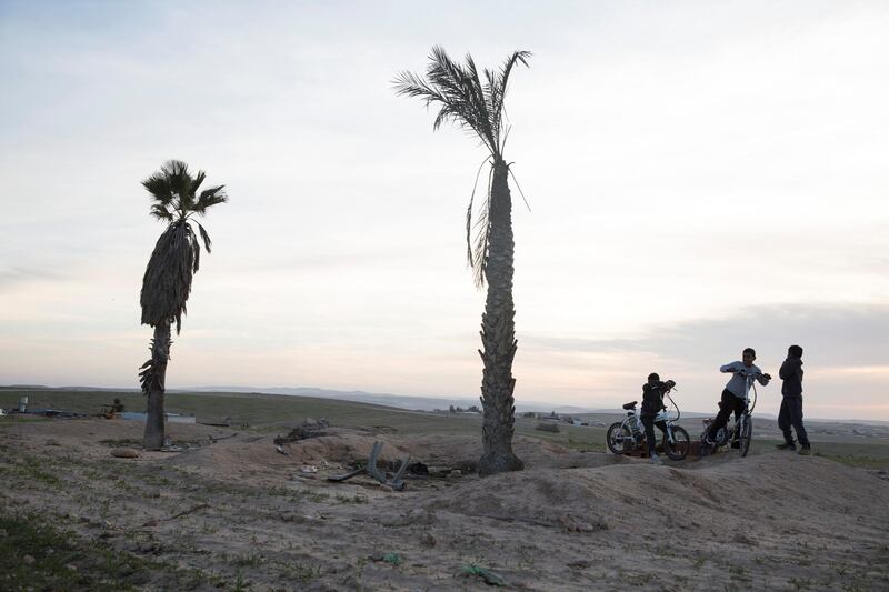 Young Bedouin boys at play in what is believed to be the area of a future giant phosphate mine thats estimated to hold 65 million tons of phosphate located to include areas of the unrecognized village of al-Poraa near the city of Arad in the Negev Desert on February 4,2018. 
Israel's Knesset is scheduled to discuss the plan which a committee of ministers have already approved, a plan by by theIsrael Chemicals subsidiary Rotem Amfert to build the mine despite the area is populated by Bedouins that fear it  will cause serious health risks and most likely evict them from their homes. Residents of Arad have also protested against the plan .(Photo by Heidi Levine for The National).
