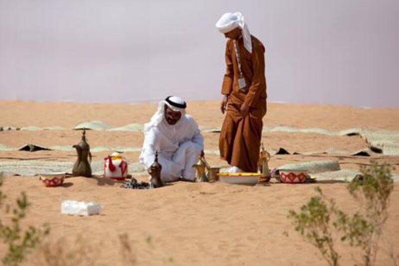 Abu Dhabi, United Arab Emirates, February 26, 2013:  Men set up a traditional Arabic coffee display during a media preview of the Qasr al Hosn Festival on Tuesday, Feb. 26, 2013, next to the historic Qasr al Hosn Forn in al Hosn neighborhood in Abu Dhabi.  The festival, a celebration of the UAE history, traditions and culture, takes place between February 28 and March 9. Silvia Razgova / The National