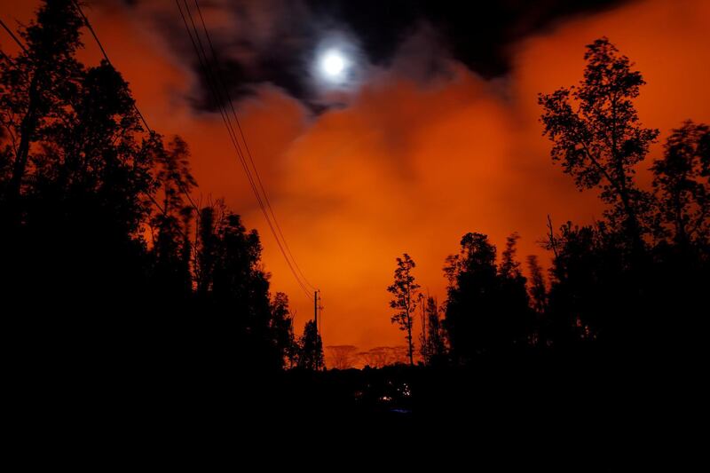 A lava flow from the Kilauea volcano illuminated the night sky, in the Leilani Estates near Pahoa, Hawaii. Marco Garcia / Reuters