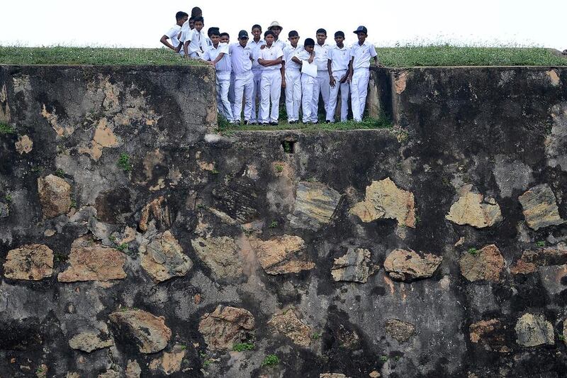 Sri Lankan schoolchildren on top of a 14th century Dutch fort near the Galle international cricket stadium watch the fourth day of the opening Test match between Sri Lanka and Bangladesh. Lakruwan Wanniarachchi / Agence France-Presse / March 10, 2017