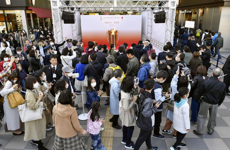 People queue as they try to watch the Olympic cauldron during the Tokyo 2020 Olympics Flame of Recovery tour at Sendai Station, Miyagi prefecture, on Saturday. Kyodo/Reuters