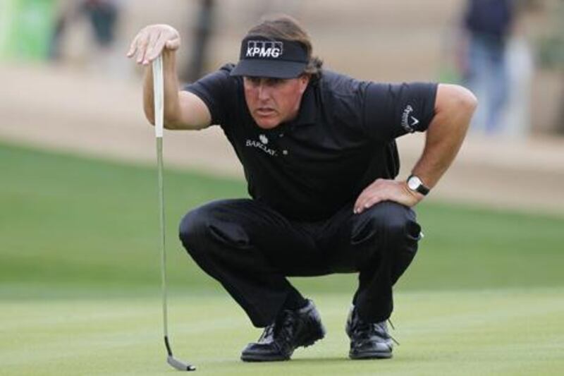 Phil Mickelson lines up a putt on his way to victory in the Phoenix Open.