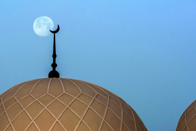 Abu Dhabi, United Arab Emirates, April 9, 2020.  The Supermoon descends upon the Saeed Mohammed Al Khalili Mosque at Khalifa City, Abu Dhabi.  
Victor Besa / The National
Section:  NA
Teporter: