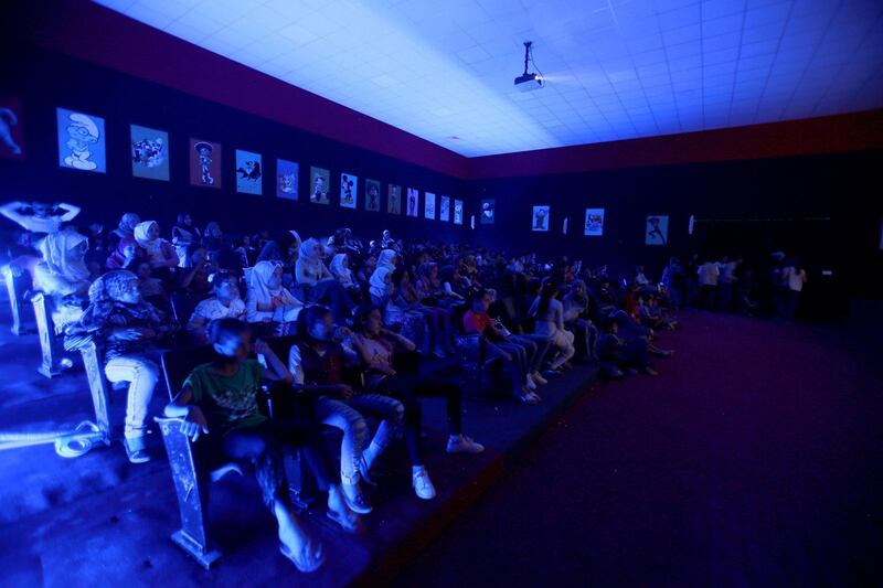 People watch the screening of a film at the Cinema Zaatari in the Jordanian Zaatari camp for Syrian refugees about 80 kilometres north of the Jordanian capital Amman.  AFP