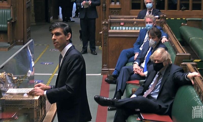 Britain's Prime Minister Boris Johnson watching as Rishi Sunak delivers his Budget statement. AFP